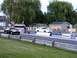 2003 Ford Crown Victoria - Two Ford Crown Victorias are lined up on a drag strip, ready for a race.