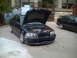 2006 Volkswagen GTI - Two sedans parked outdoors, one with its hood open revealing the engine compartment.