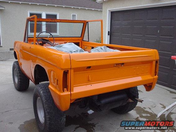 Orange Ford Bronco, doors off, parked in driveway