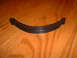 1978 Ford Mustang II - A black rubber trim piece with a red accent strip is shown on a wooden background.