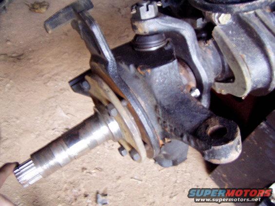 Front axle spindle and steering knuckle assembly, likely from a truck