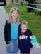 1986 Ford Bronco - Two smiling children pose for a photo outside a house on a sunny day.