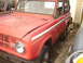 2006 Ford F1 - This classic SUV is red with white side stripes and appears to be a 1977 model.