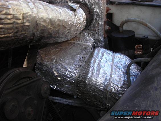 engine bay with insulated hoses and belts