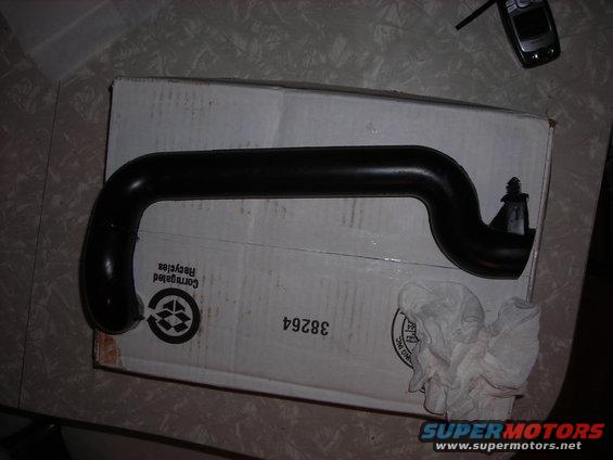 Black rubber hose on a cardboard box with some crumpled paper