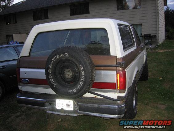 1987 Ford Bronco rear with spare tire mounted on tailgate, brown and white paint scheme
