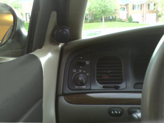 2001 Ford Crown Victoria interior showing dashboard, air vent, and aftermarket tweeter speaker
