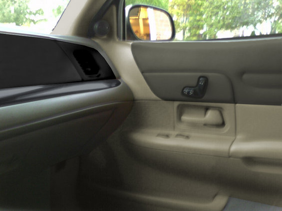 Interior shot of a car's passenger side door panel and dashboard. Shows seat controls and door handle
