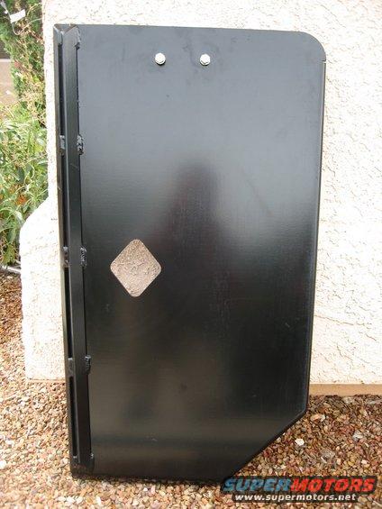 Black steel door with diamond cutout and SuperMotors.net watermark