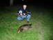 1995 Mercury Grand Marquis - A man poses with a rifle next to a deceased beaver on a grassy area at night.