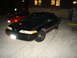1992 Ford Crown Victoria - A black 1992 Ford Crown Victoria is parked outside a building at night, with another car visible in the background.