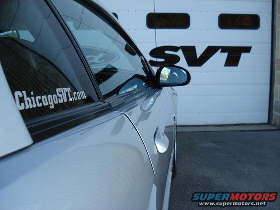 Silver car side with ChicagoSVT.com sticker and SVT logo on garage door
