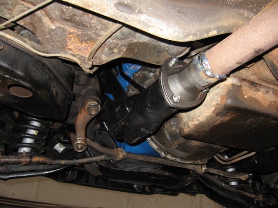 Underside view of exhaust pipe and drive shaft connection