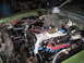 1973 Ford Ranchero - The engine bay of a car is shown with a V8 engine, carburetor, and many wires and hoses.