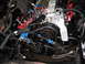 1973 Ford Ranchero - Close-up view of an engine bay, a blue-painted engine block and various black mechanical components.