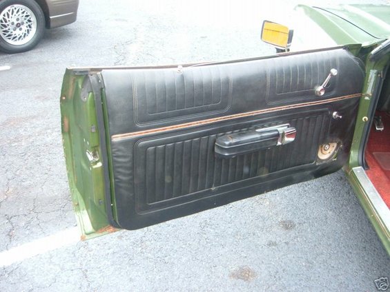 Green 1973 Ford Ranchero interior door panel with black upholstery
