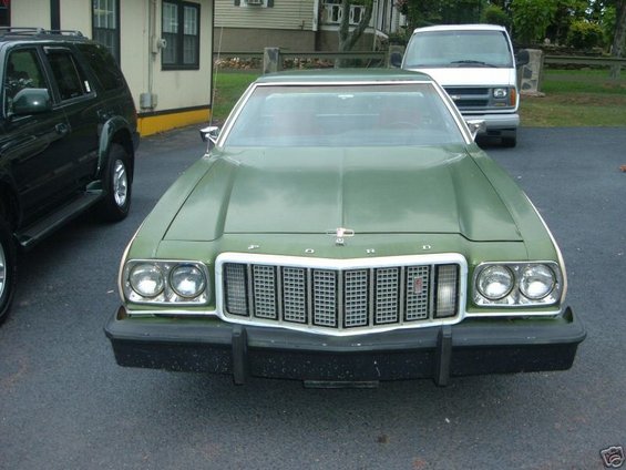 1973 Ford Ranchero front view, parked next to a black SUV and white van