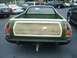 1973 Ford Ranchero - The rear of a green Ford Ranchero pickup truck with wood-grain paneling on the tailgate.