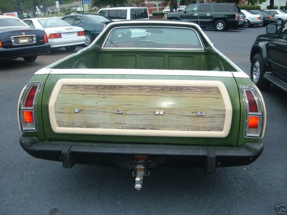 Green Ford Ranchero with wood-grain paneling on tailgate, rear view