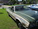 1973 Ford Ranchero - A 1973 Ford Ranchero with wood grain trim is parked in a suburban driveway.