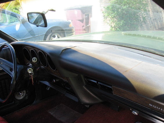 1973 Ford Ranchero interior dashboard with cracked dash pad and woodgrain trim