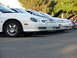 1995 Ford Taurus - Several 1995 Ford Taurus models are lined up with their hoods open.
