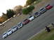 1995 Ford Taurus - A line of Ford Taurus sedans are parked diagonally in a lot, with people watching from the grass.