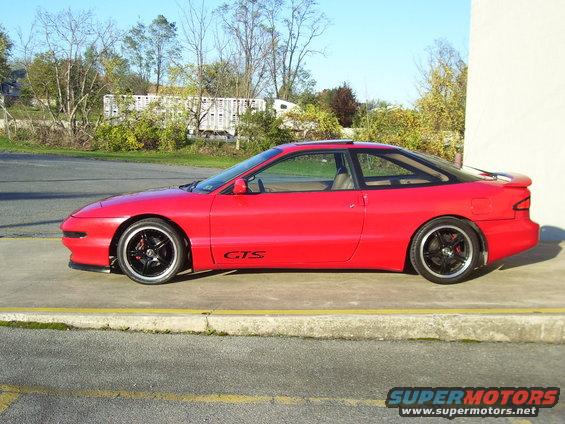 red coupe with black rims and GTS decal on the side