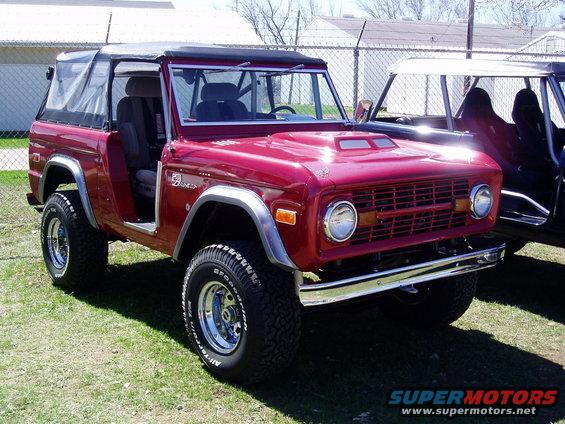 Red Ford Bronco with soft top, 3q-front view