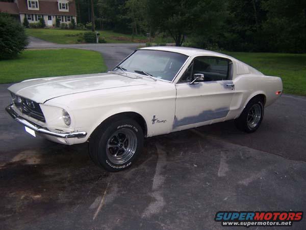 1968 Ford Mustang coupe, white with primer spots on driver's side door and fender