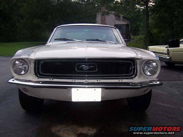 White 1968 Ford Mustang front view, chrome bumper, black grille with horse emblem, license plate area empty