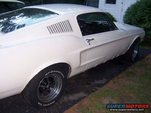 White 1967 coupe with rear quarter panel louvers and BFGoodrich tires