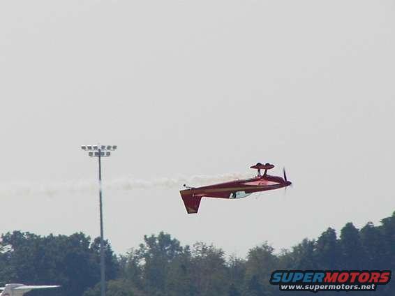 Extra 330XS.  Low altitude inverted fly-by.