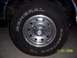 1994 Ford Bronco - A close-up shot focuses on the tire and wheel of a vehicle, with a date stamp visible.