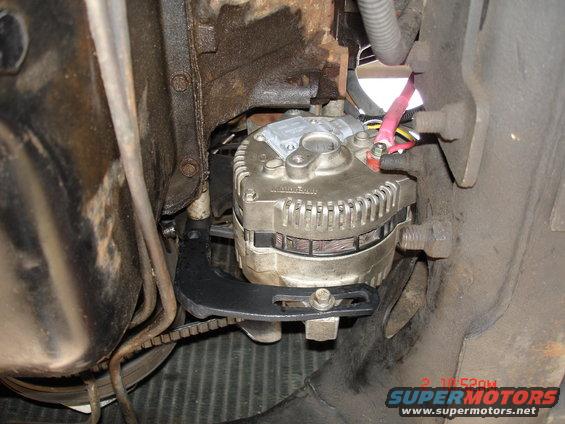 Alternator mounted with bracket and belt. Wires connected to terminals