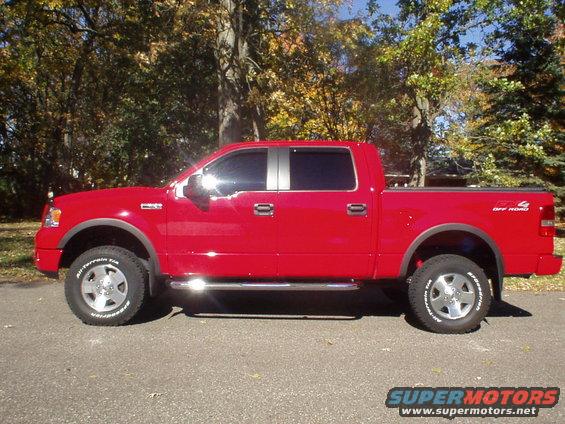 Red Ford F-150 pickup truck, side view. Has FX4 Off Road badging