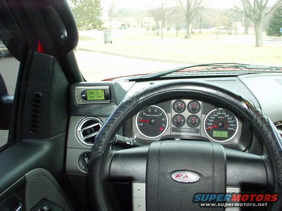 Dashboard of a red Ford F-150 with FX4 badging on the steering wheel and a digital gauge