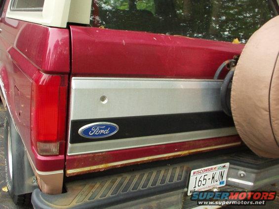 Rear of a red 1994 Ford Bronco with a spare tire cover and Wisconsin plates