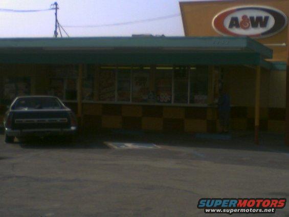 dark sedan parked in front of an A&W restaurant