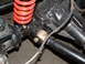 1994 Jeep YJ - This image shows a close-up view of a vehicle's suspension system, focusing on a red coilover shock absorber and associated hardware.