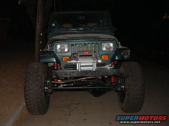 Green 1994 Jeep YJ front view with winch and large tires