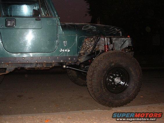 Green 1994 Jeep YJ with large off-road tires and modified front end