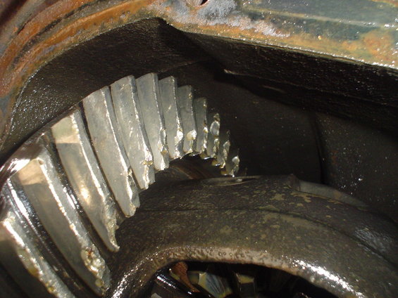 Close-up of damaged differential gears with chipped teeth