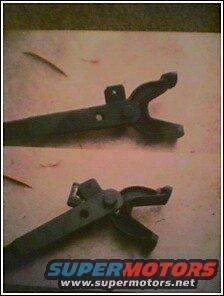 Metal part with two prongs, top and bottom views. SuperMotors logo visible