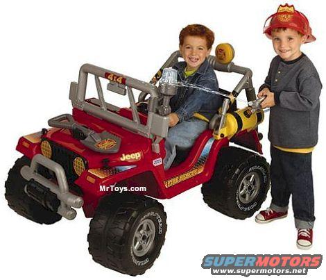 Red toy Jeep with two young boys, one in the driver's seat and one standing beside it
