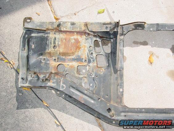 rusted metal frame section with various holes and mounting points