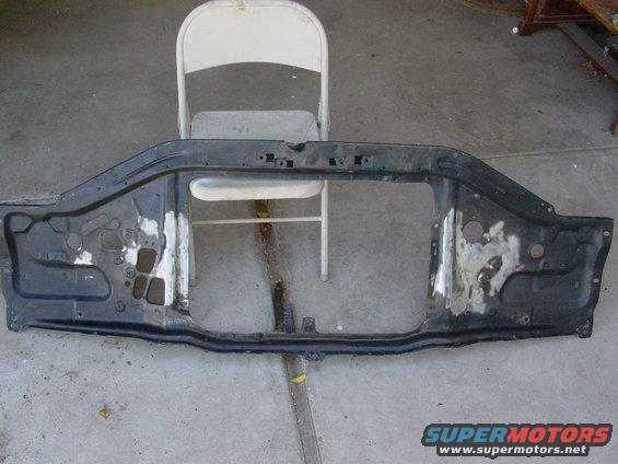 Radiator support frame, possibly from a Ford truck or SUV, with areas of rust and repair
