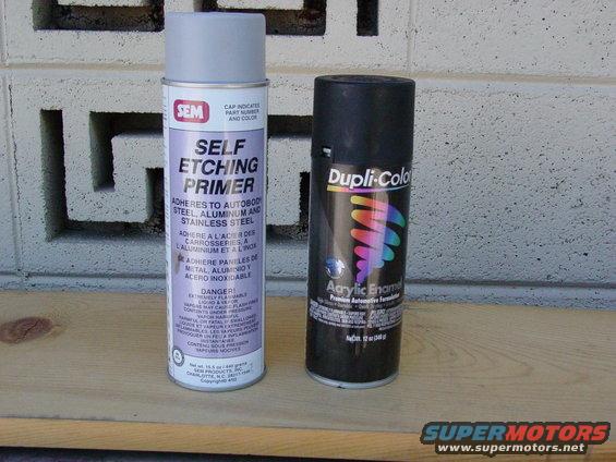 SEM self etching primer and Dupli-Color acrylic enamel spray cans on a wooden surface