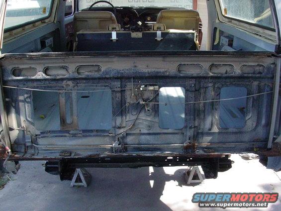 Rear of a Ford Bronco with tailgate removed, showing interior structure and seats