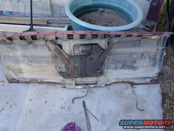 tailgate mechanism with rusty parts and wires